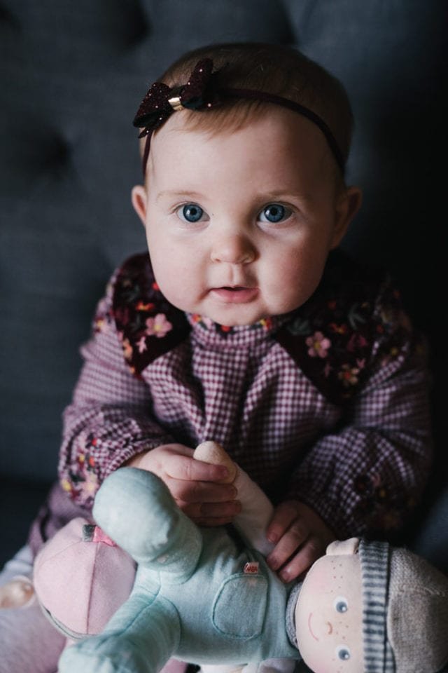 Beautiful baby gift in burgundy dress with a doll