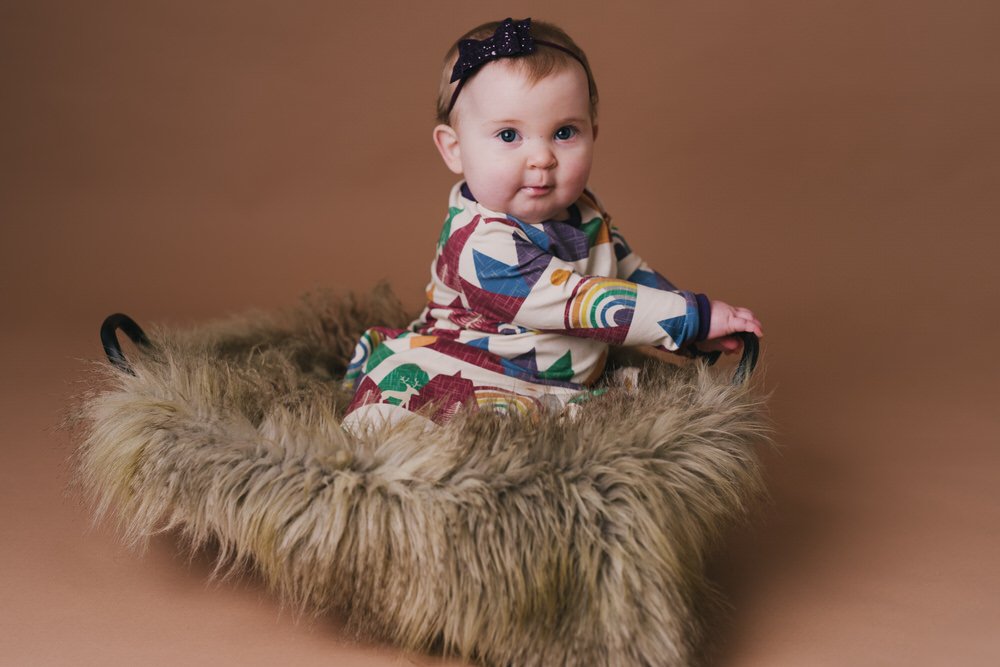 Baby in rainbow coloured dress from Kallidora Creations