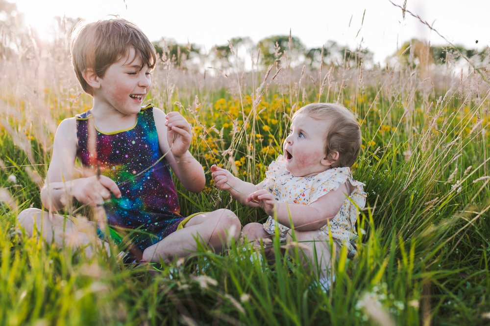 Sibling portrait in wildflower field 