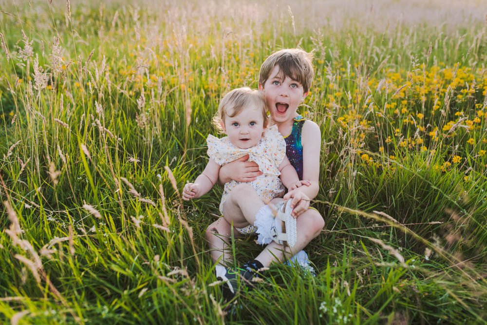 Sibling portrait in wildflower field 