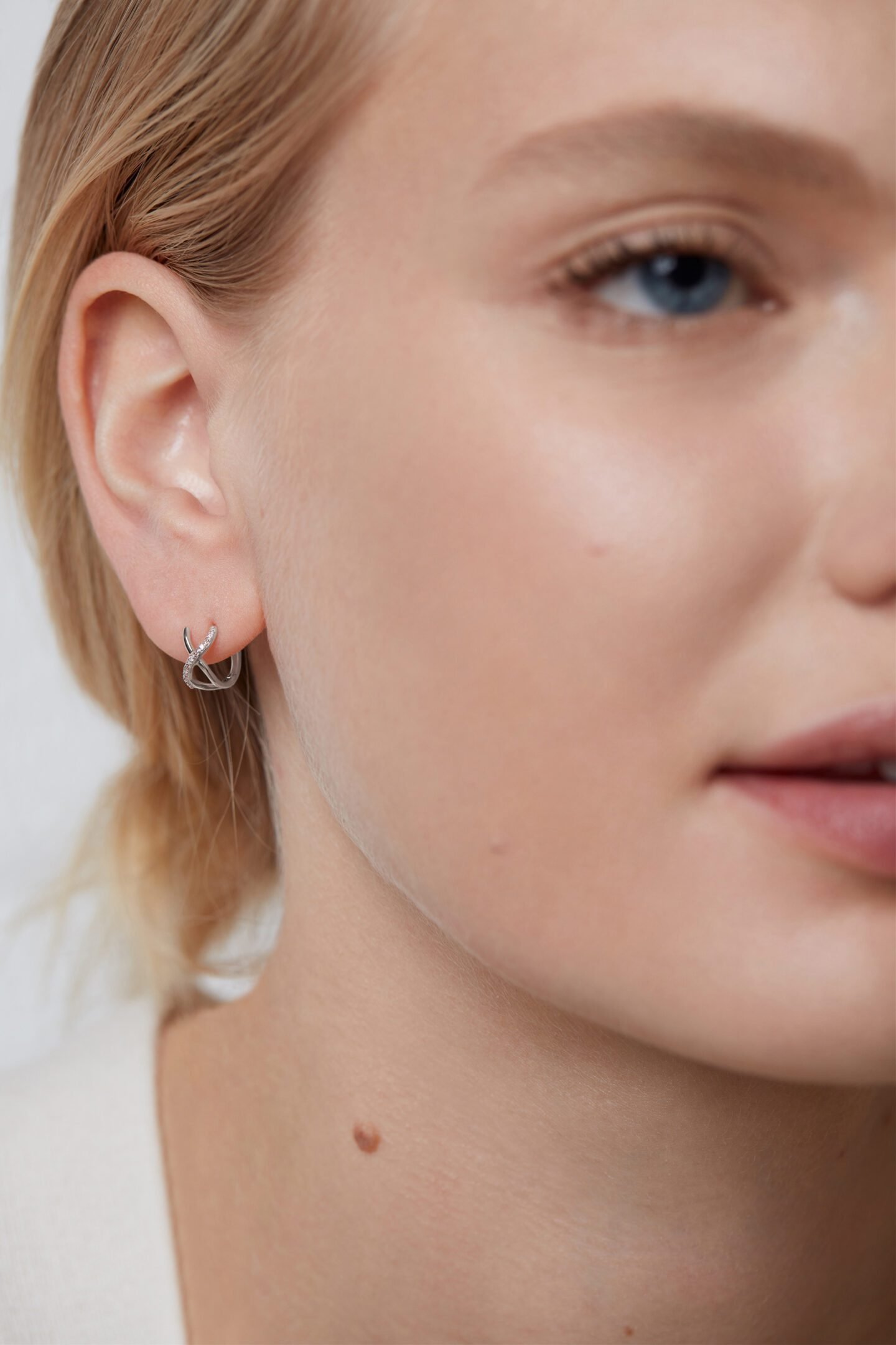 White gold crossover huggie earrings 