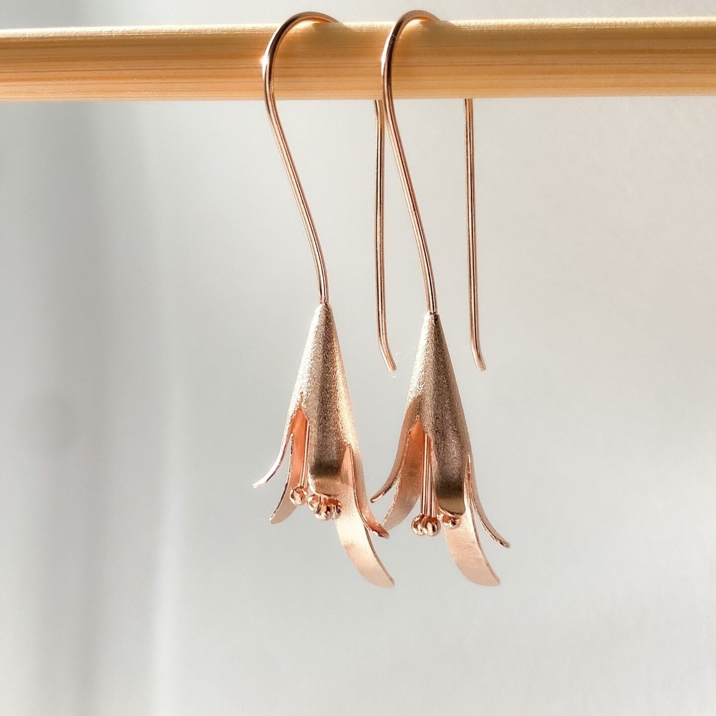 Rose gold flower dangle earrings